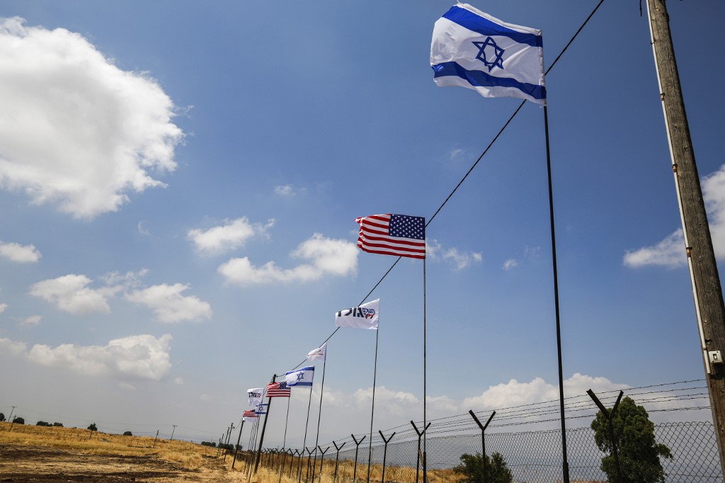 on June 14, 2019 shows Israeli and US flags flying along the side of a road in the settlement of Qela Bruchim in the Israeli-annexed Golan Heights. (AFP)