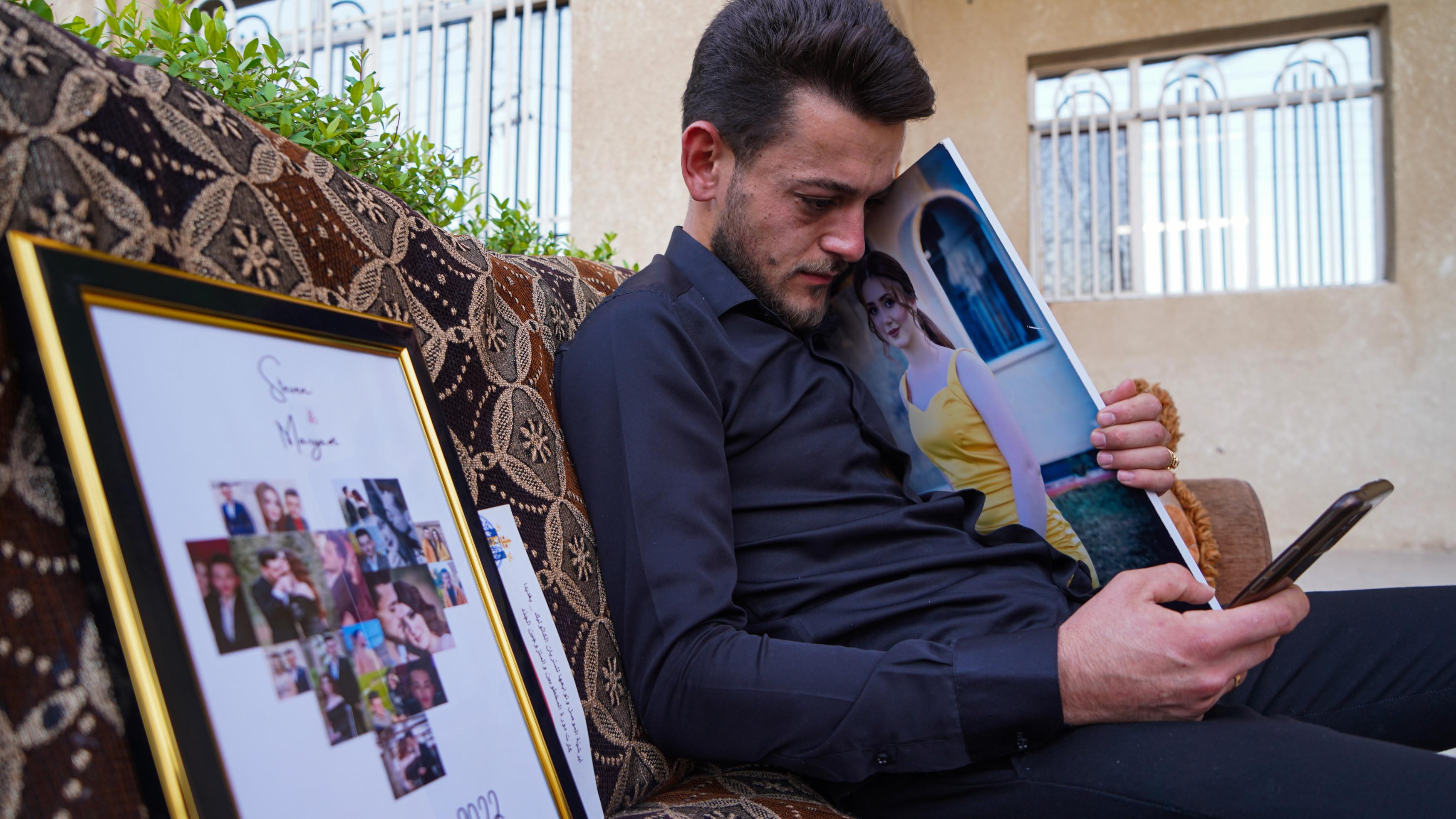 Steven Nabil spends most of his days looking at photos of his fiancee Maryam Naeem (MEE/Ismael Adnan)