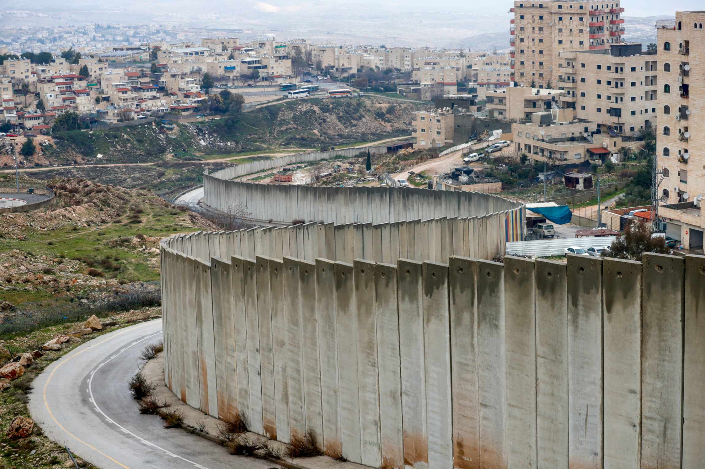 The Israeli settlement of Pisgat Zeev and the Palestinian Shuafat refugee camp are pictured on 11 February 2020 (AFP)