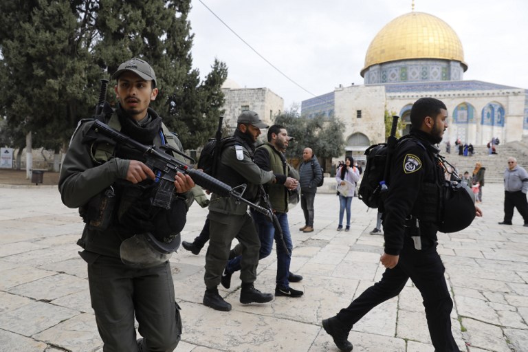 Israeli police detain a Palestinian demonstrator at al-Aqsa compound on 18 February (AFP)