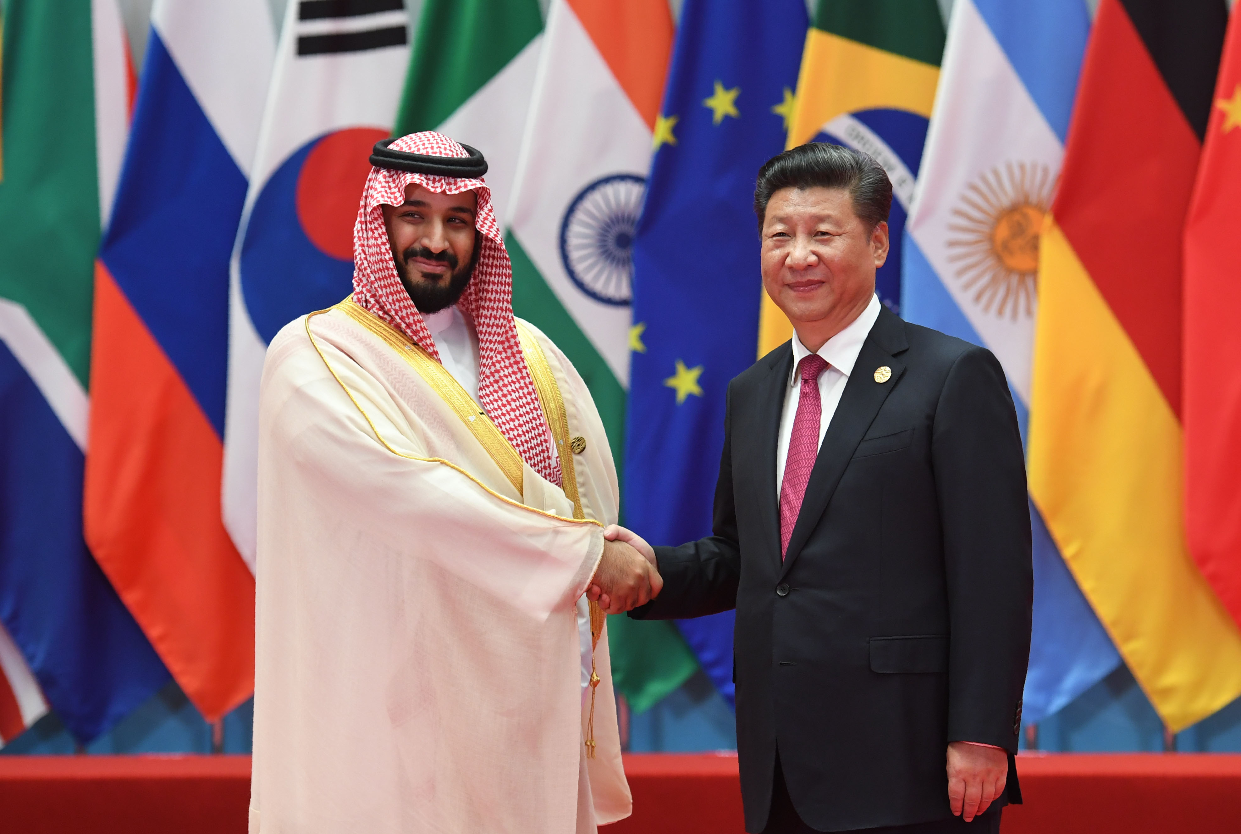 Xi greets Saudi Arabia’s Mohammed bin Salman in Hangzhou, China, in 2016 (Reuters)