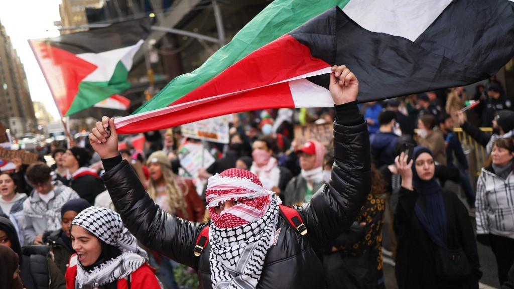Pro-Palestine activists march as they participate in a Global Strike for Gaza, on 18 December 2023 in New York City.