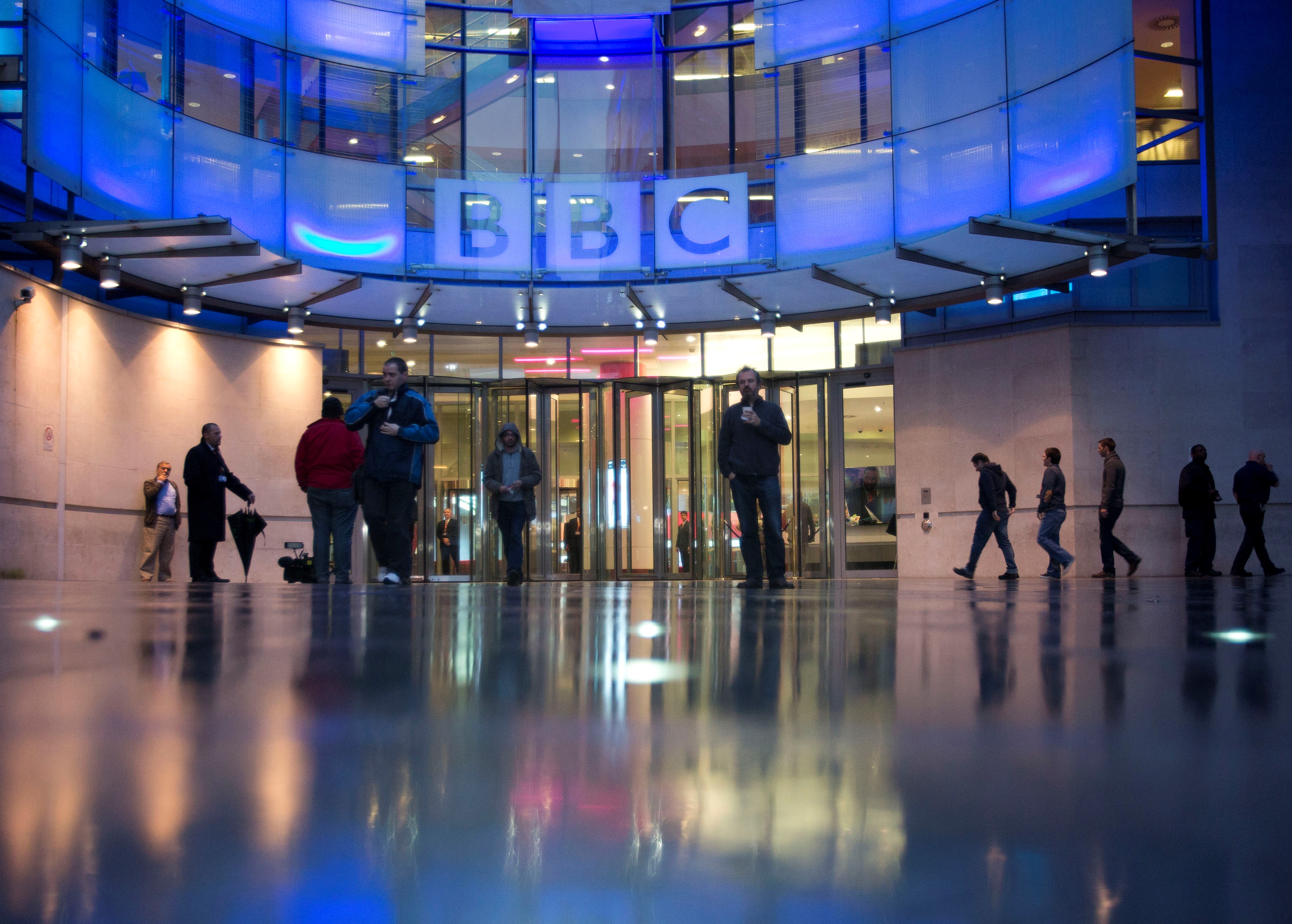 People arrive at, and leave, the BBC headquarters (Reuters)