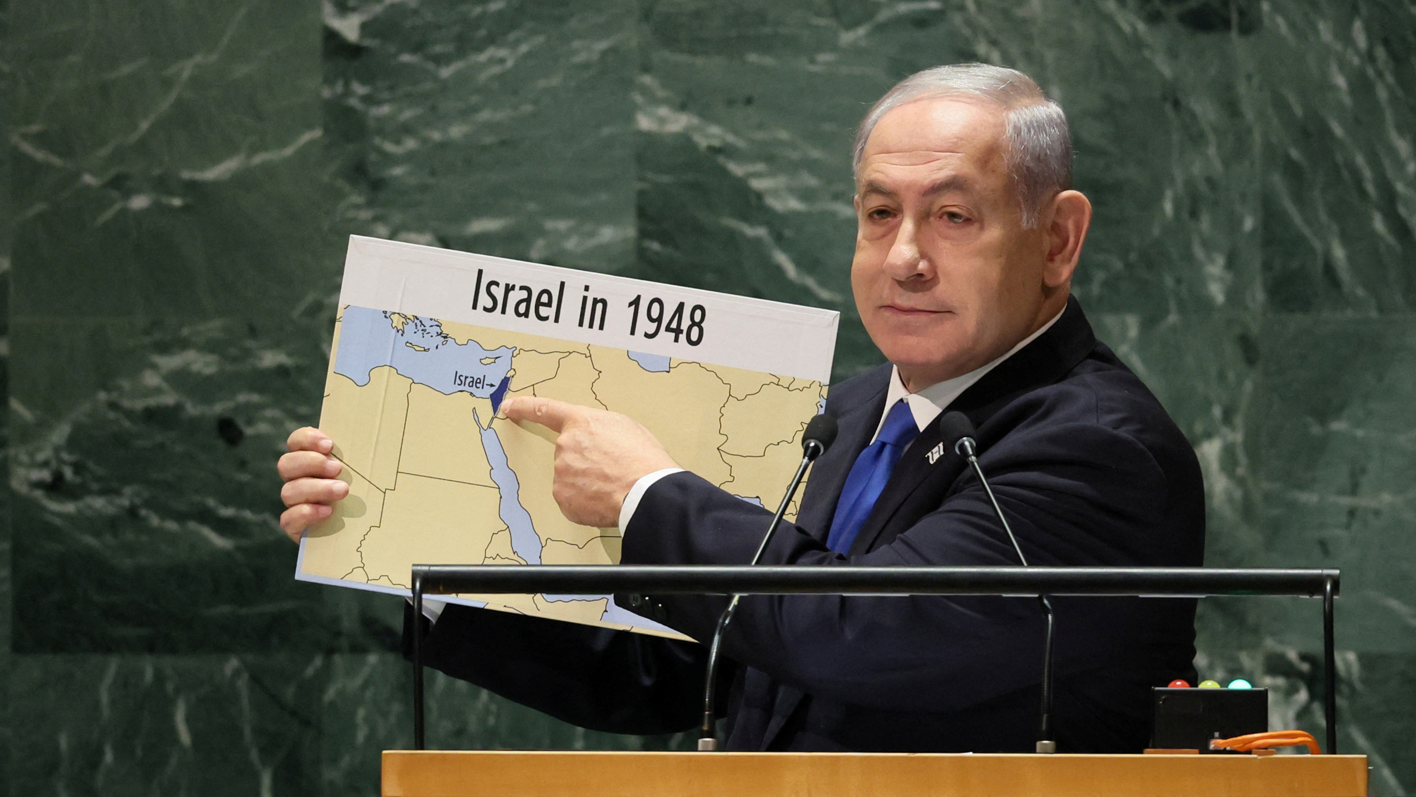 Israeli Prime Minister Benjamin Netanyahu holds up a map showing the occupied West Bank and Gaza as part of Israel at the UN on 22 September 2023 (Reuters)