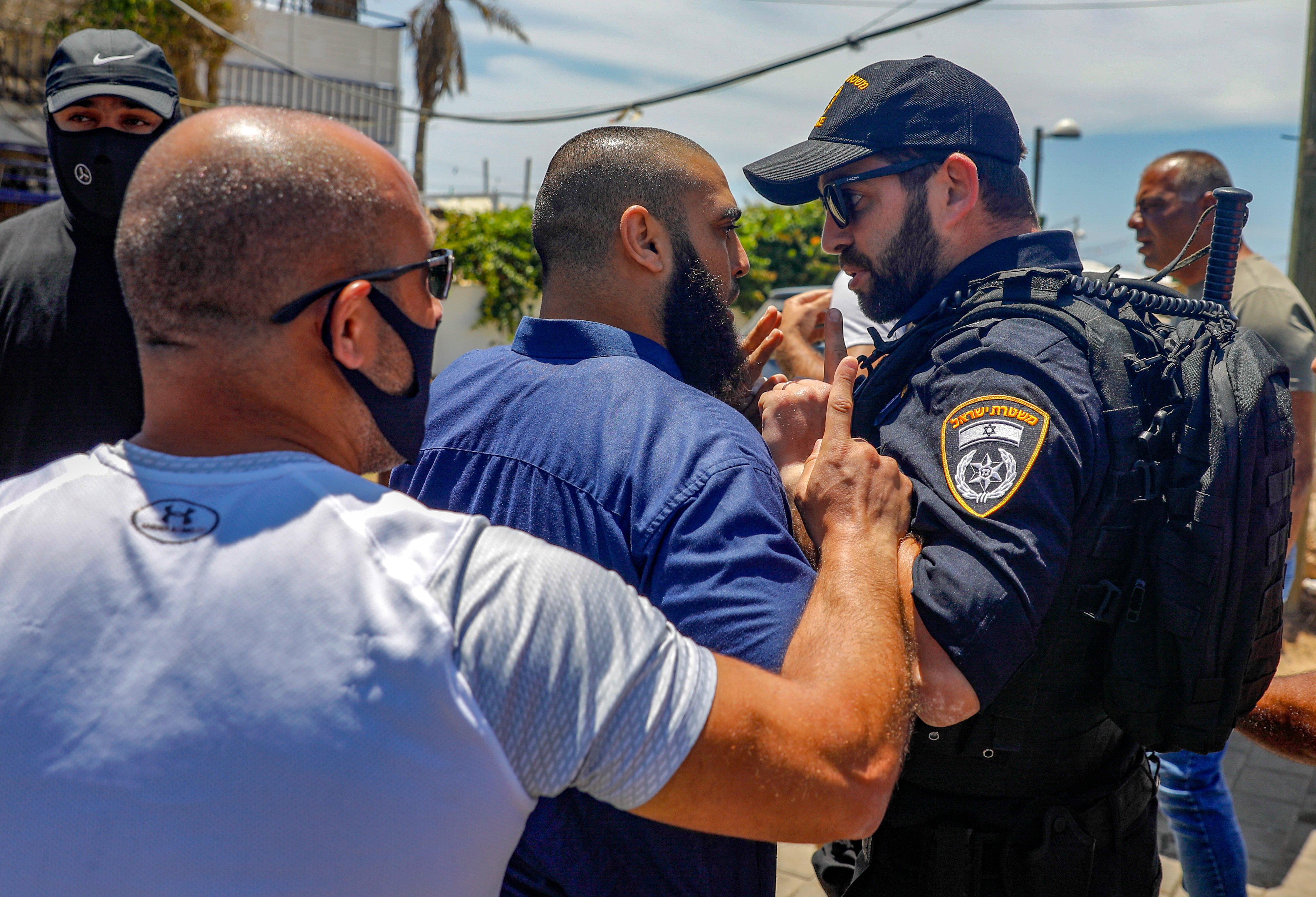 A Palestinian citizen of Israel calls out Israeli police forces during a demonstration in Jaffa over the fate of al-Isaaf cemetery on 12 June 2020 (AFP)