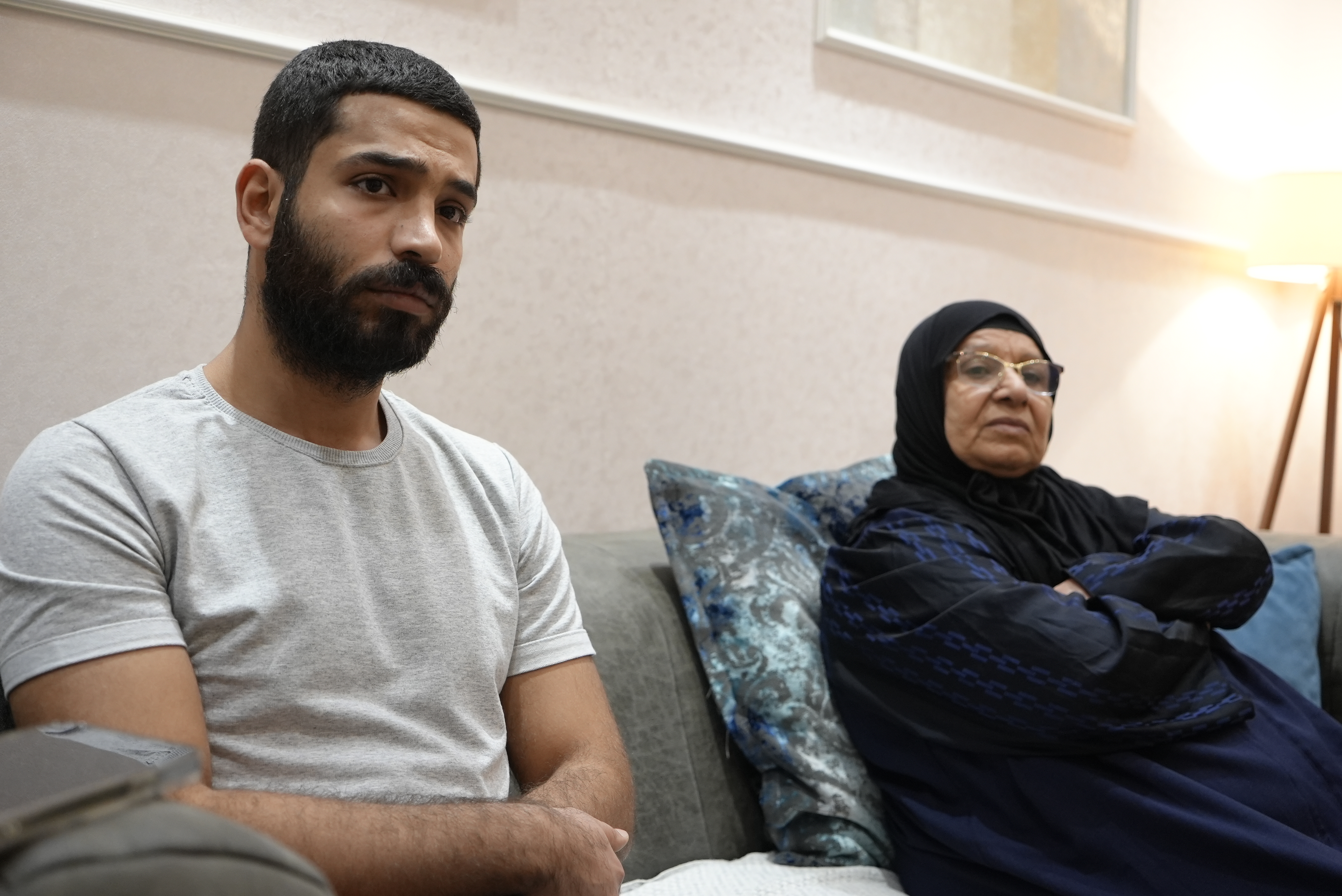 Baha Mousa's mother Hadiqa Marzooq (r) sits alongside her grandson and Mousa's son of 