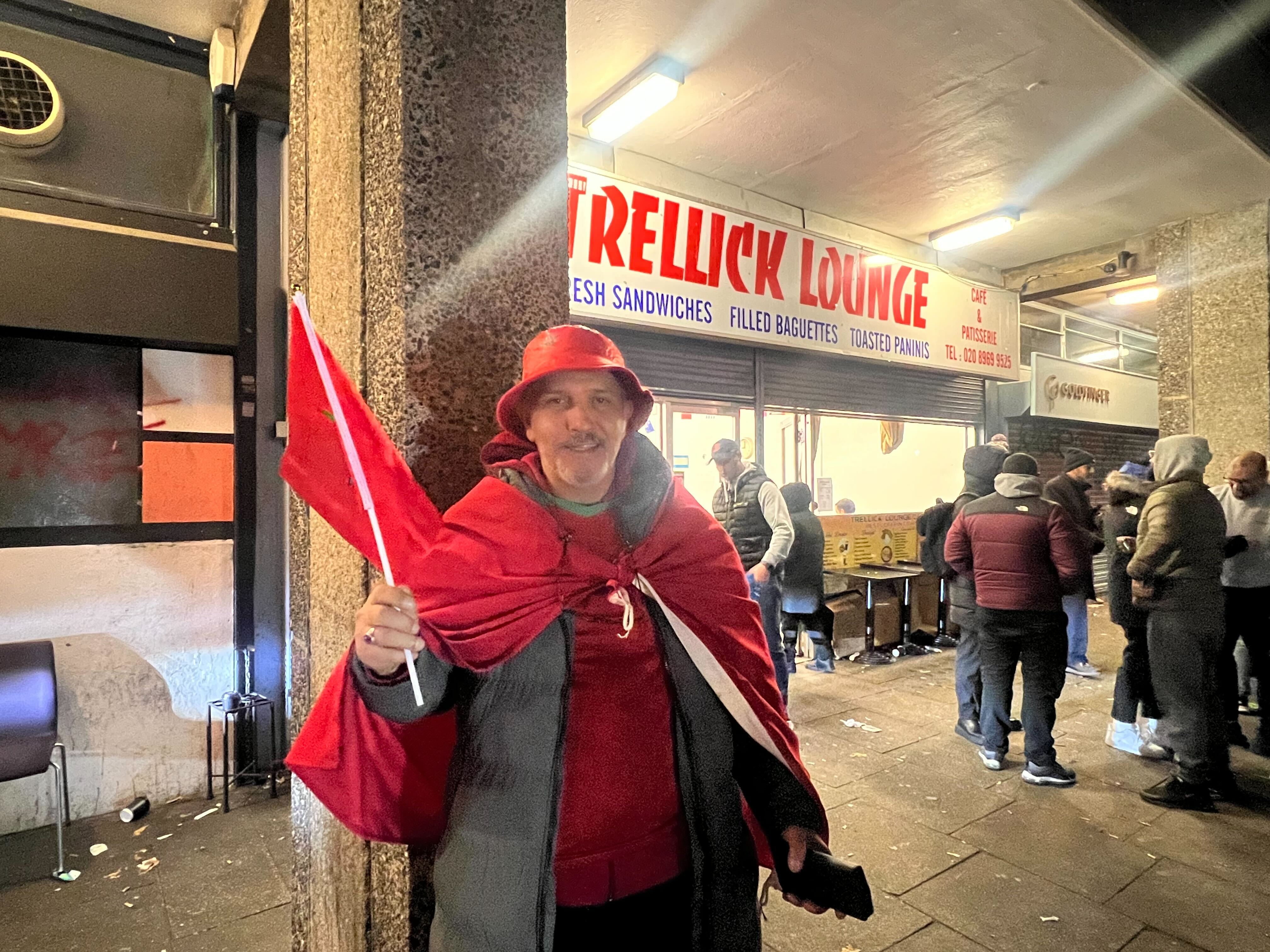 Mohamed remains hopeful after Morocco's defeat and stands outside the Trellick lounge on Golborne road (MEE/Areeb Ullah)