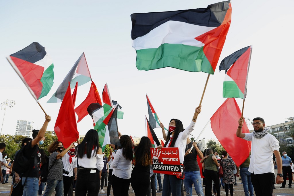 The Palestinian flag is waved during a protest in Tel Aviv over Israeli annexation on 6 June 2020 (AFP/File photo)