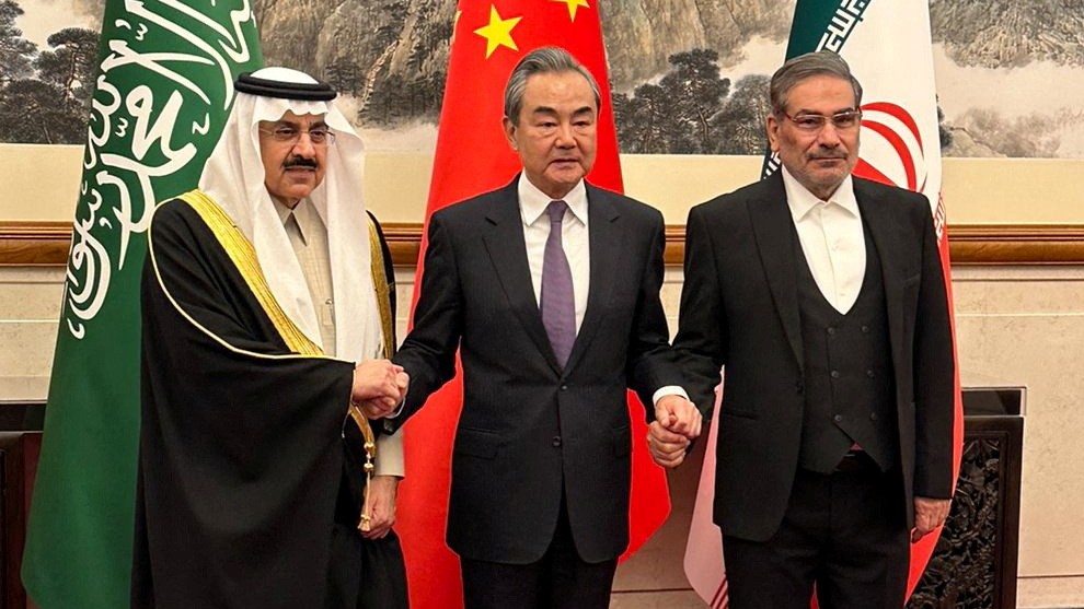 China’s top diplomat, Wang Yi, is pictured with Saudi Arabia’s Musaad bin Mohammed al-Aiban and Iran’s Ali Shamkhani, in Beijing on 10 March 2023 (Reuters)