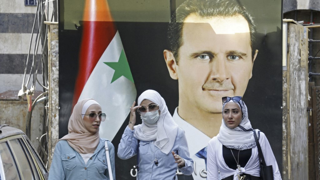 A poster of President Bashar al-Assad hangs in Damascus in September 2021 (AFP)