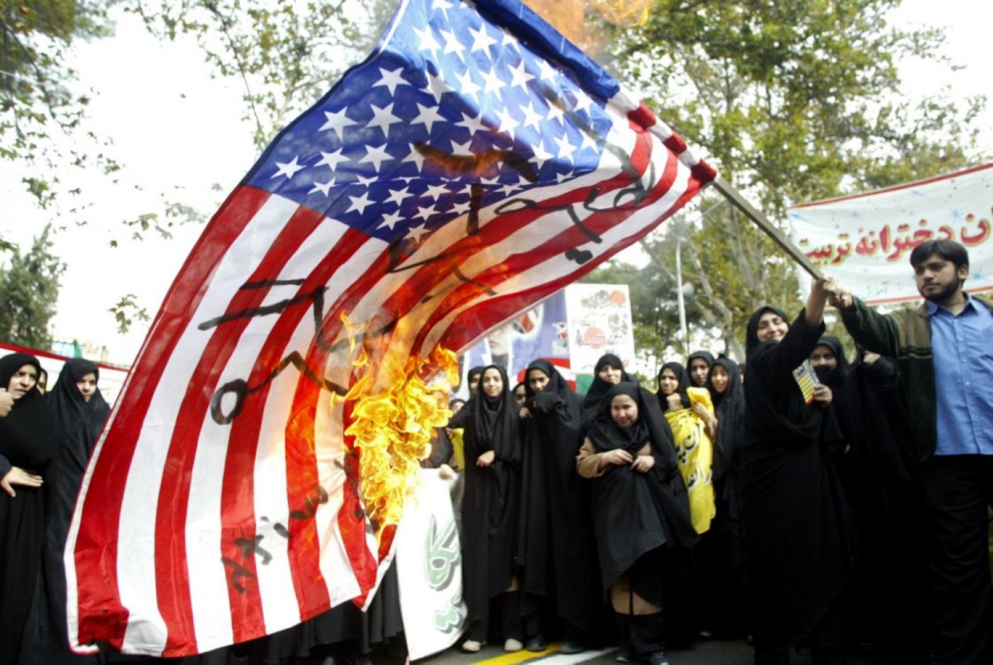Iranian students burn an American flag outside the former US embassy in Tehran in 2004 (AFP)