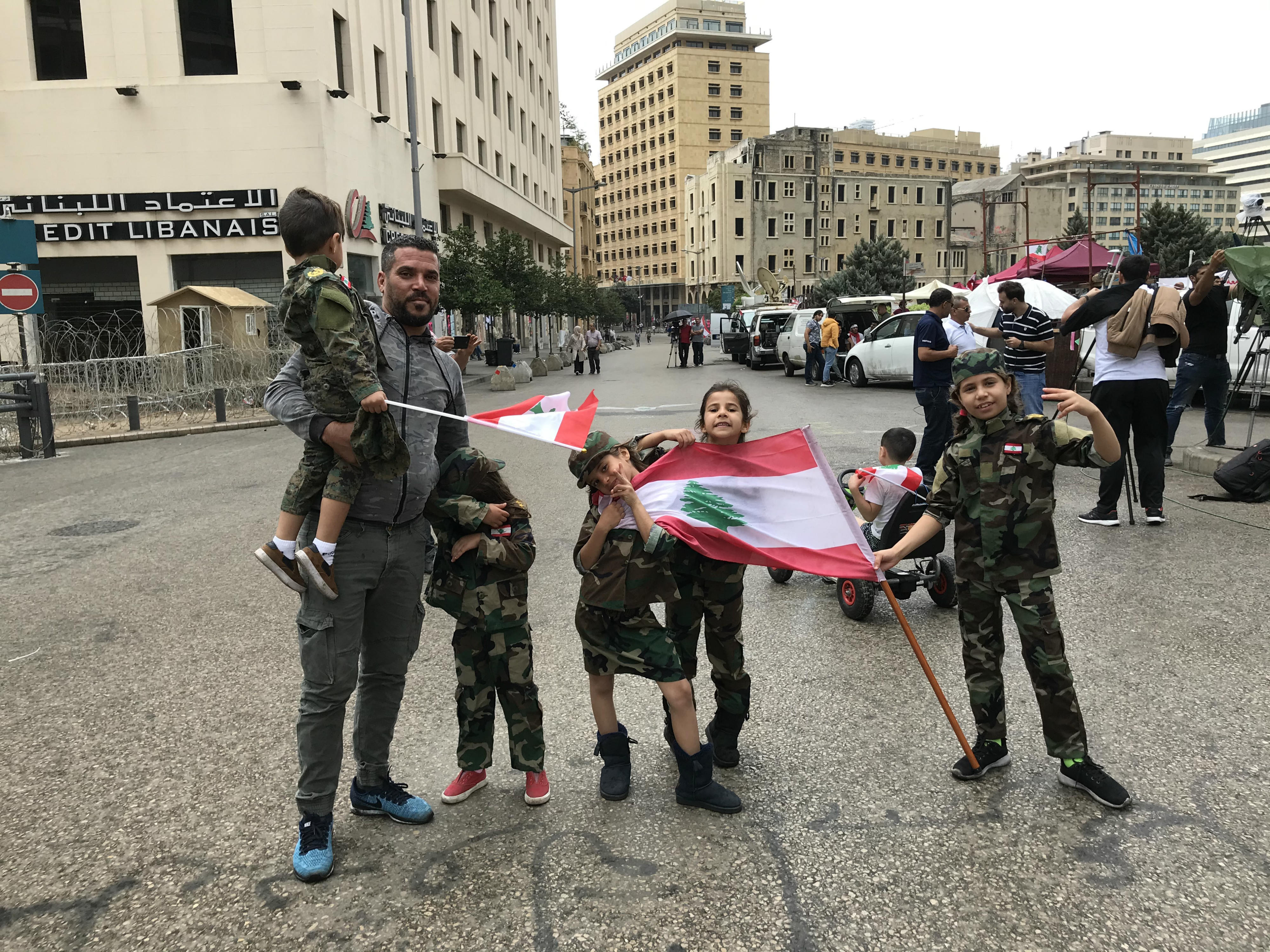 Mohammed Hussein and his children protest in central Beirut (MEE/Heba Nasser)