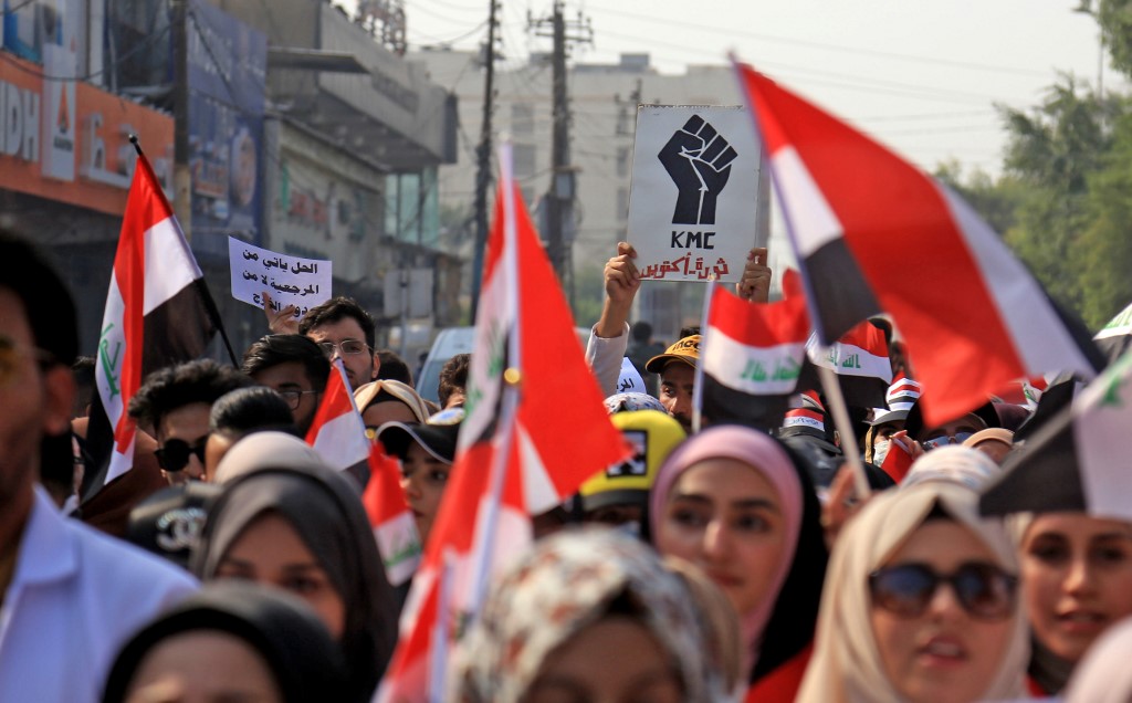 Iraqis take part in an anti-government protest in Karbala on 12 November (AFP)