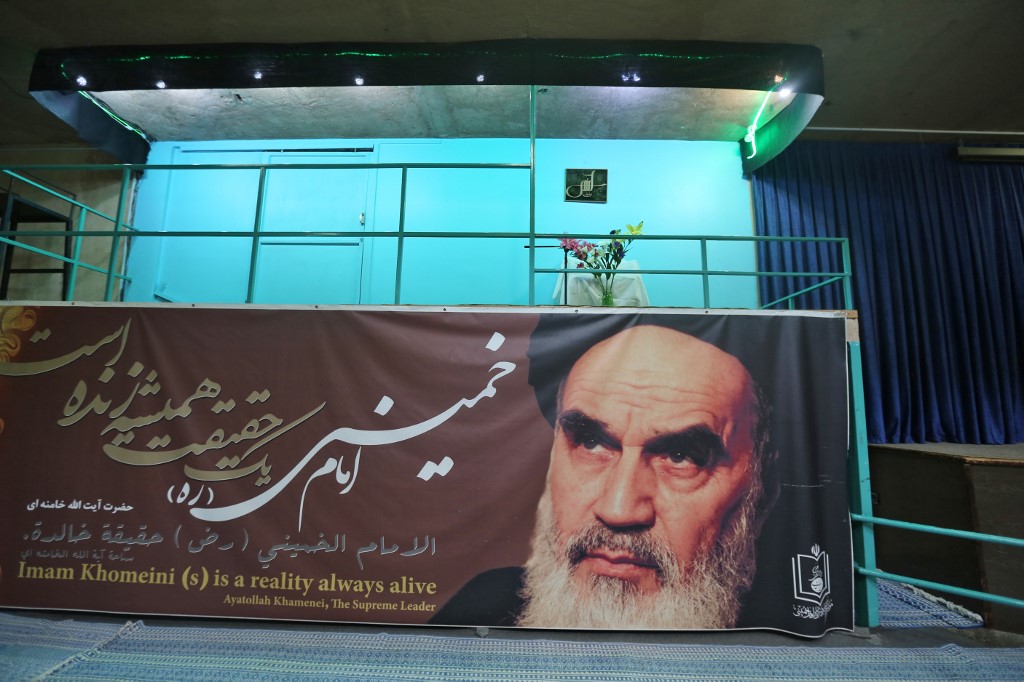 Former Iranian Supreme Leader Ayatollah Khomeini’s image appears on a banner in Tehran in May 2019 (AFP)