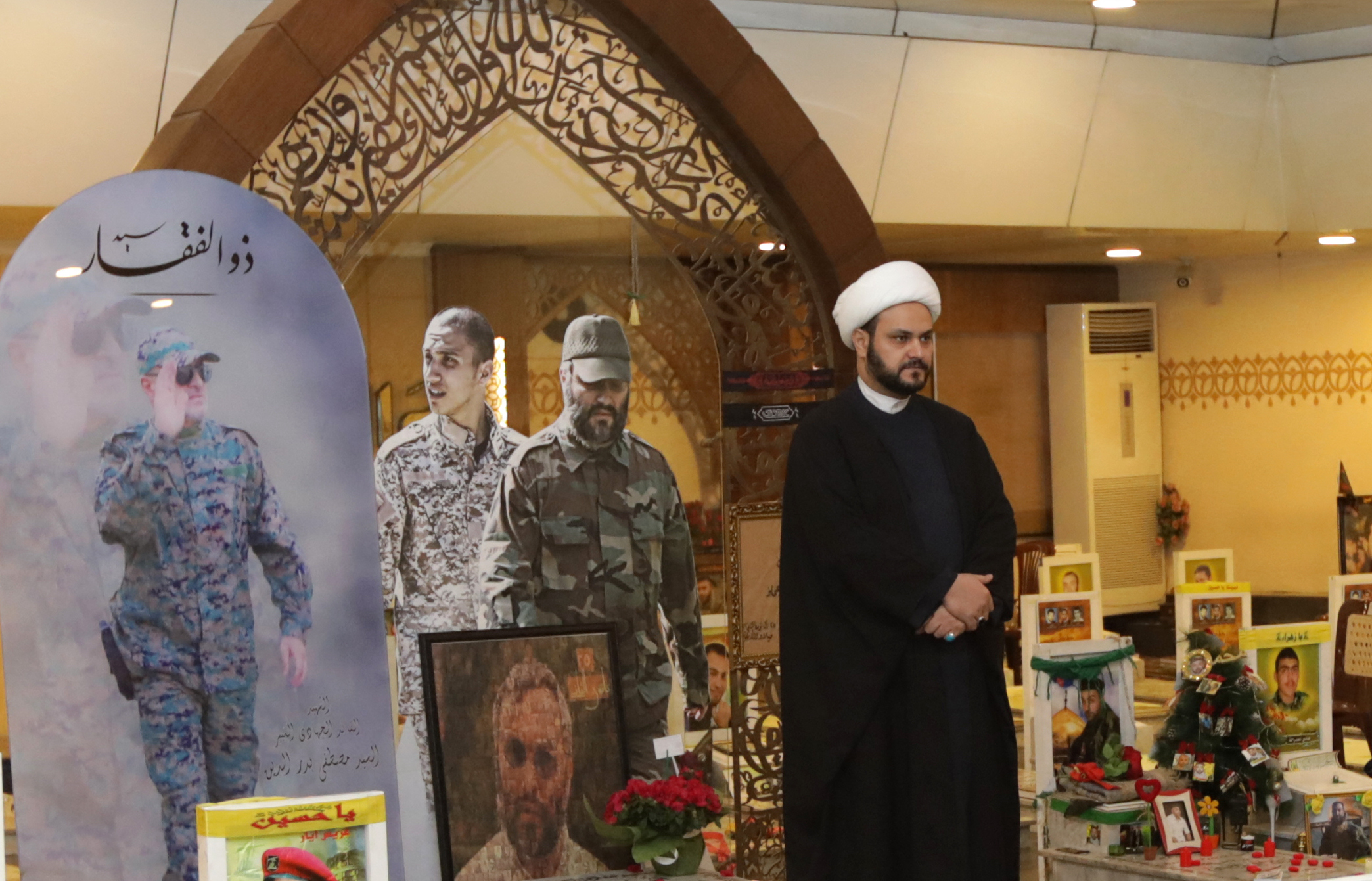 ecretary General of Shitte Iraqi Al-Nujabaa movement Akram al-Kaabi (L) poses for a picture by the tombs of slain Hezbollah military leaders in Beirut's southern suburb on February 13, 2018.