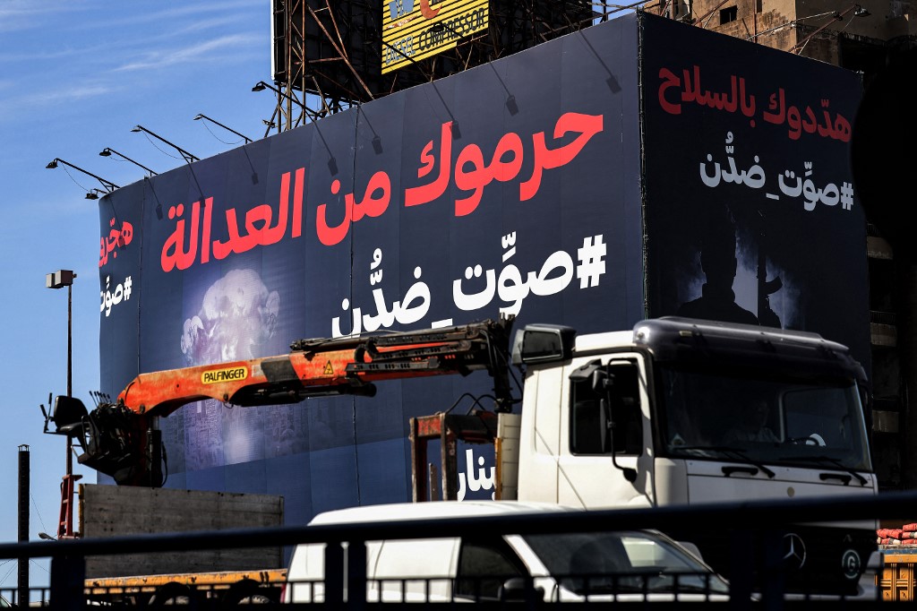 An electoral billboard in Beirut, pictured on 13 April 2022, reads: ‘They deprived you of justice, #vote_against_them’ (AFP)