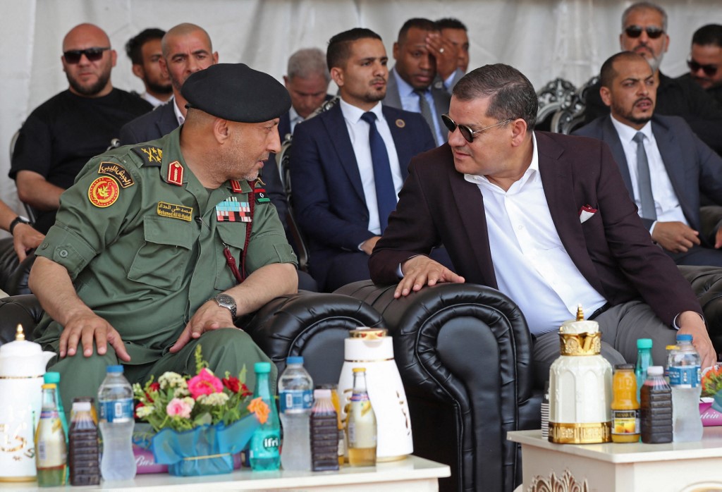 Libyan army chief of staff Lieutenant General Mohamed al-Haddad (L) speaks with Libya’s interim prime minister, Abdul Hamid Dbeibah, in Tripoli on 3 July 2022 (AFP)