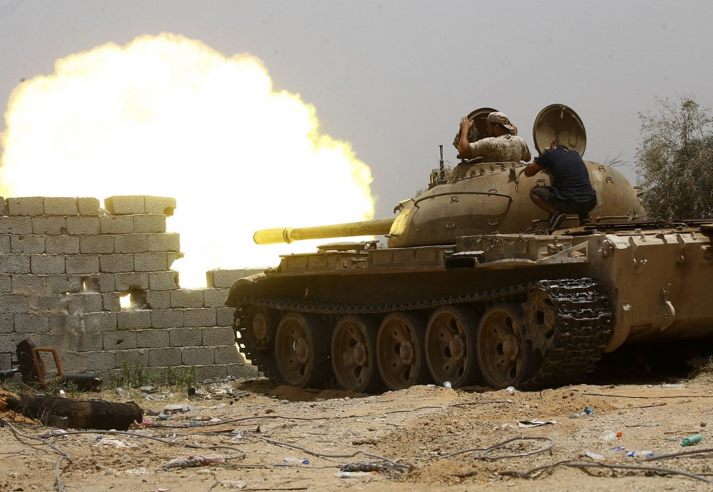 Libyan tanks are fired south of Tripoli on 13 June (AFP)