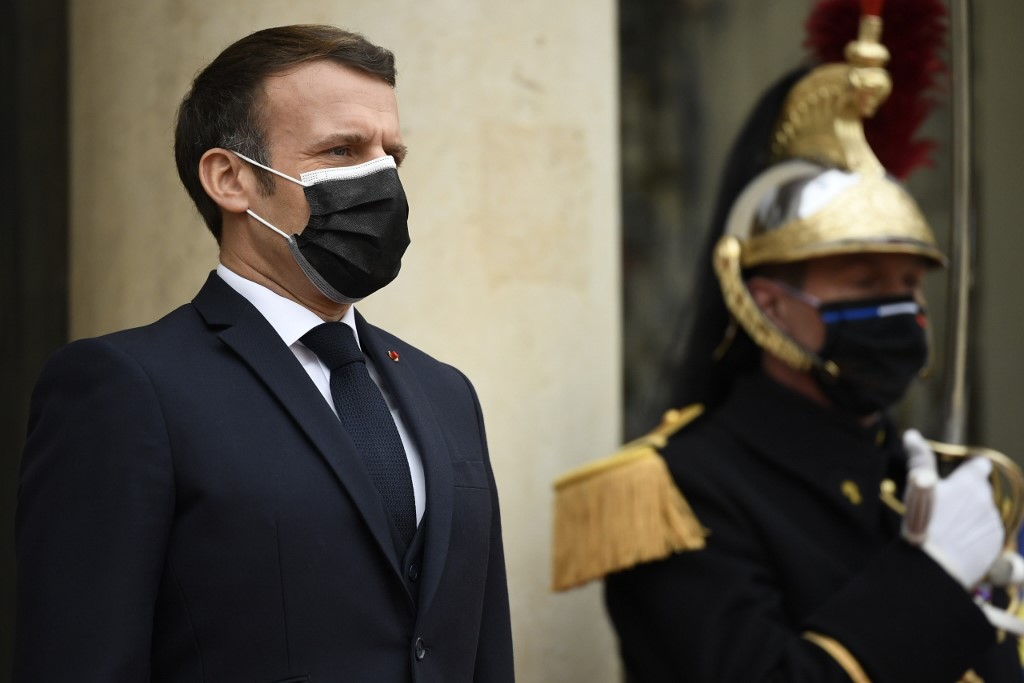Macron is pictured at the Elysee on 7 December (AFP)