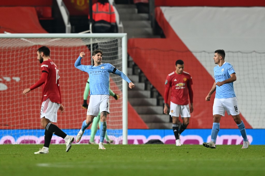 Manchester City's English defender John Stones (C) reacts during the English League Cup semi final first leg football match between Manchester United and Manchester City at Old Trafford in Manchester, north west England, on January 6, 2021