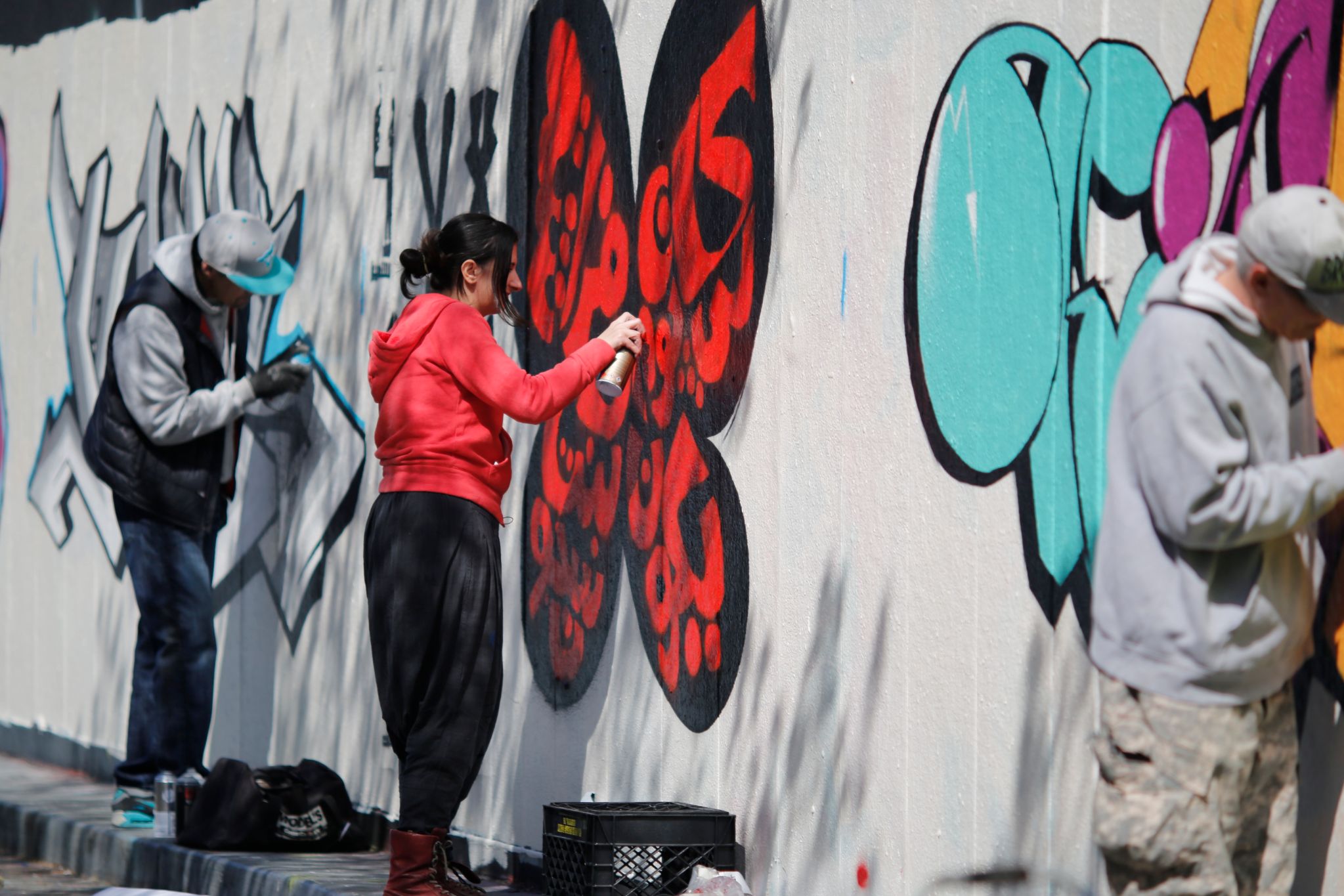Bahia Shehab sprays a wall with street art in New York (Mark Nikolas)