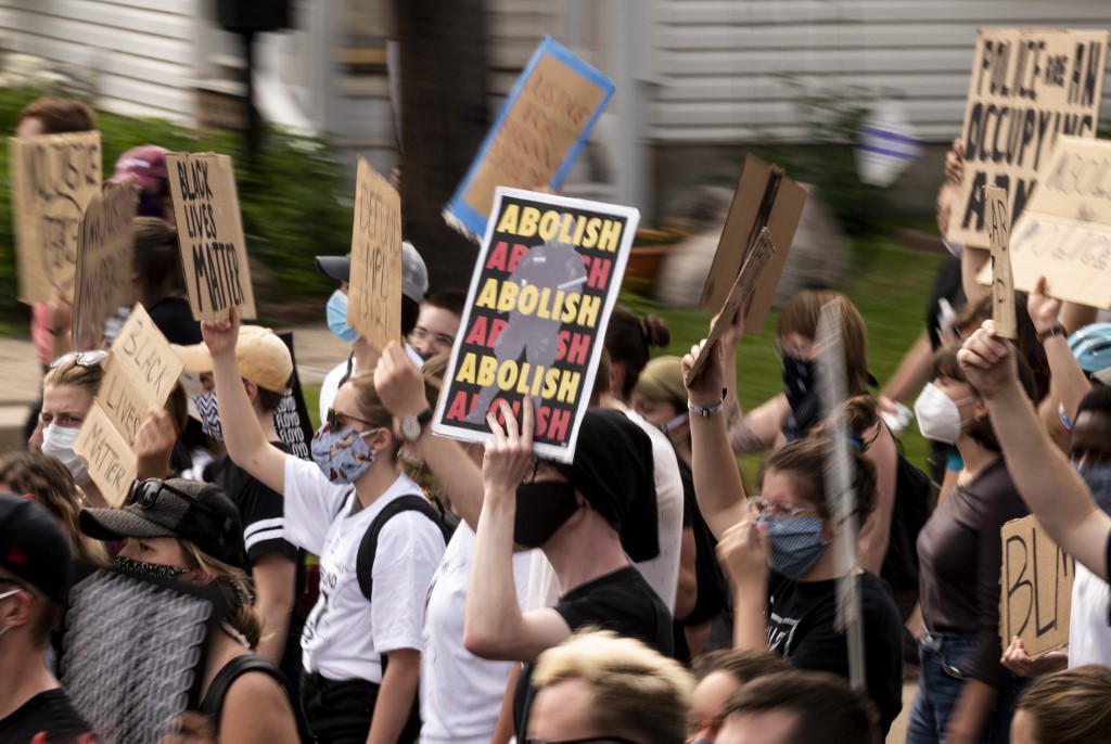 Demonstrators calling to defund the Minneapolis Police Department march on 6 June (AFP)
