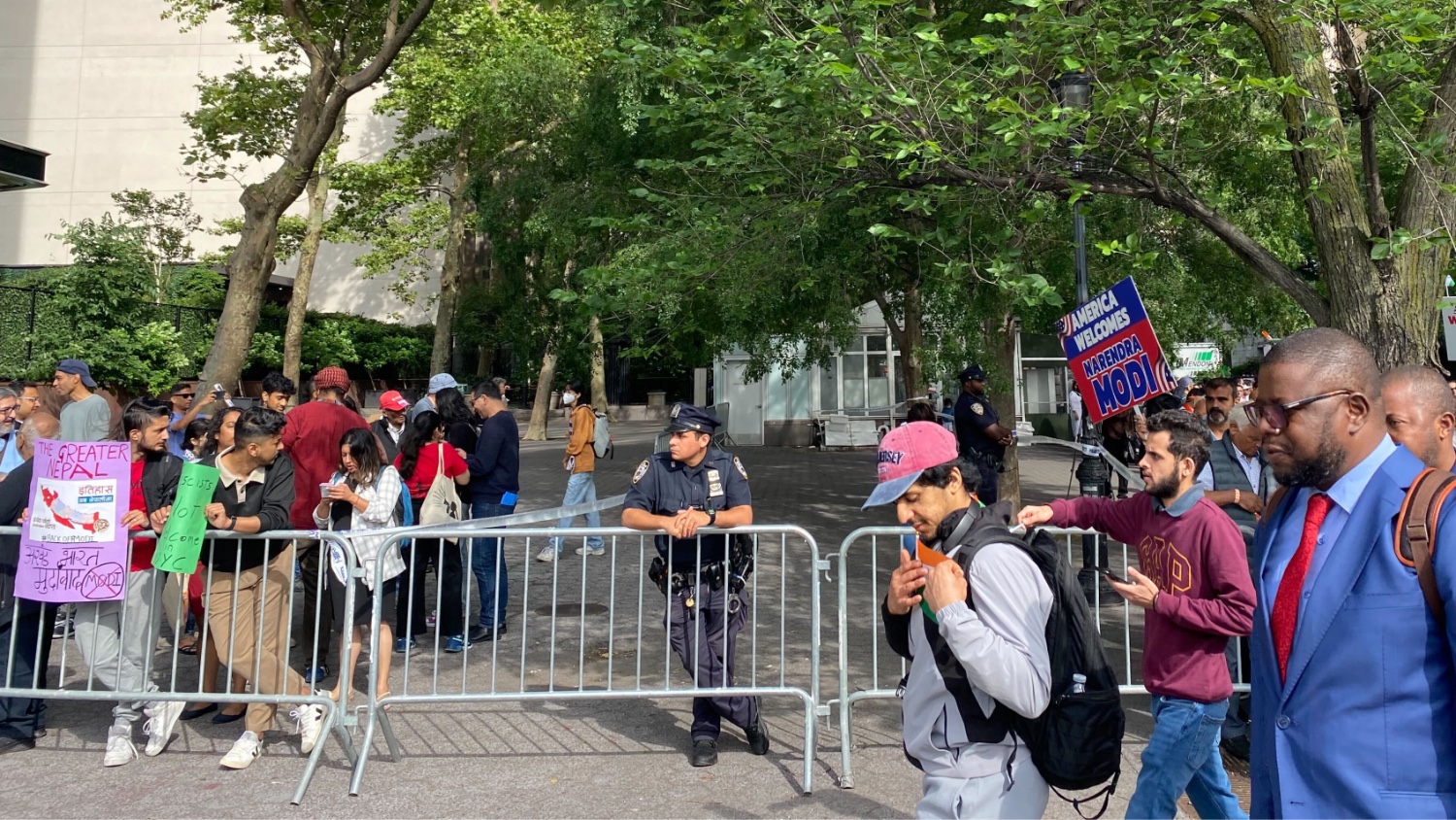 Crowds of people protesting Modi's visit cross paths with Modi supporters in New York City on 21 June 2023.