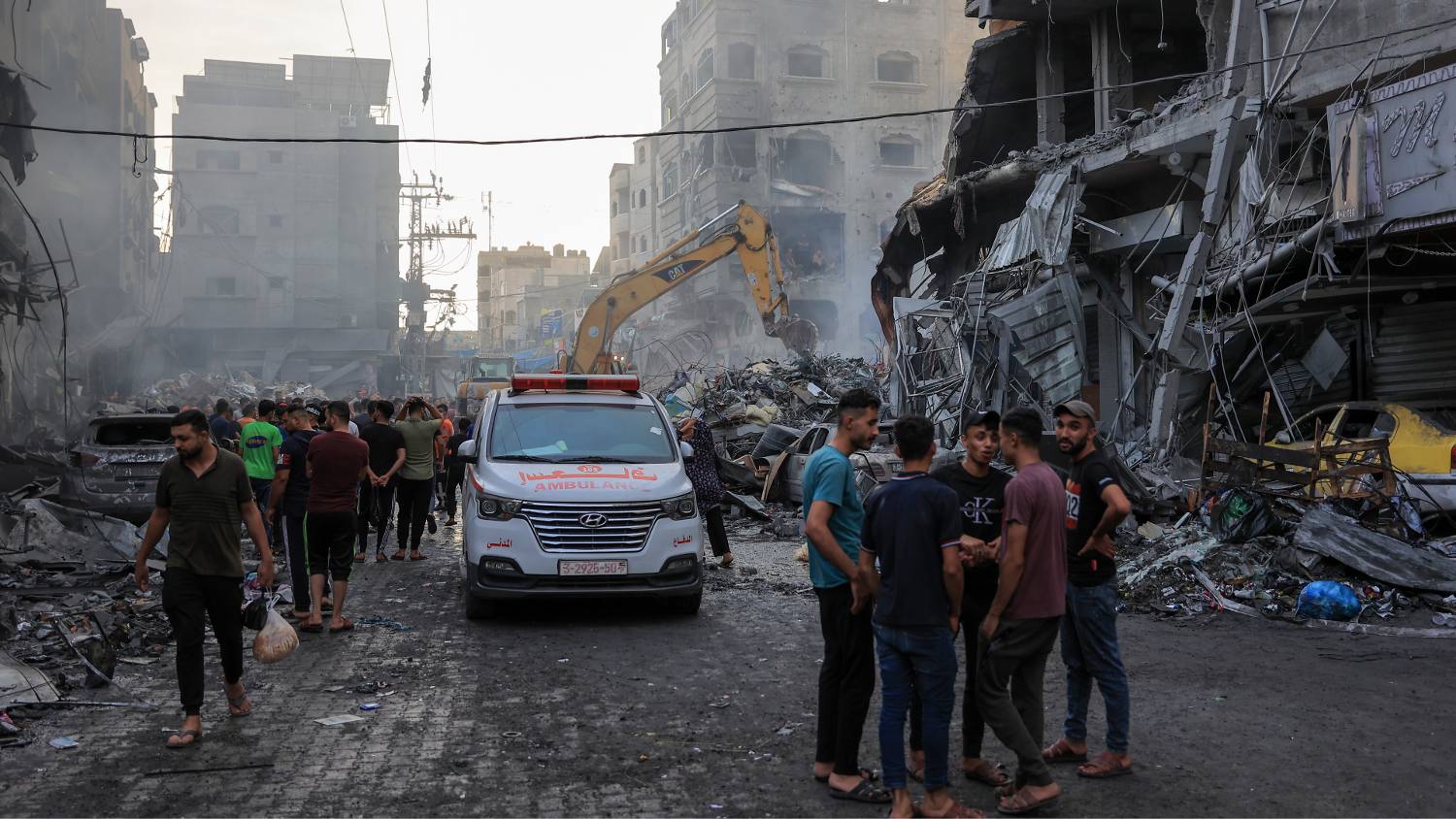 An ambulance drives through the wreckage of an Israeli air strike in Gaza.