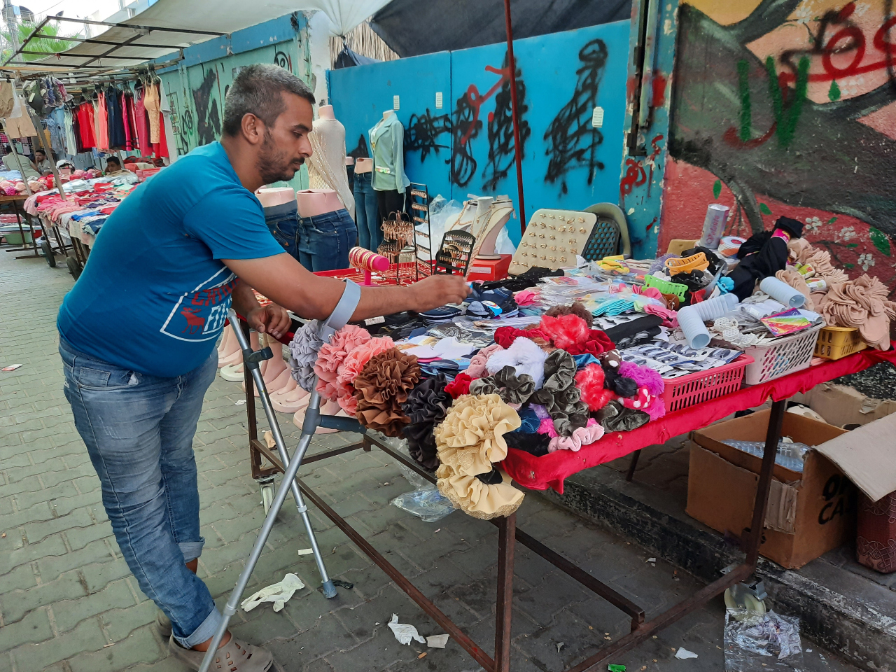 Street hawker Mohammed al-Amarin has cerebral palsy and a problem with the nerves in his feet (MEE/Ahmed Al-Sammak)