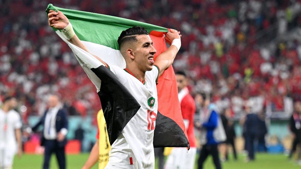 Moroccan defender Jawad El Yamiq waves the Palestinian flag after his team won its World Cup match against Canada at Doha’s Al-Thumama Stadium on 1 December 2022 (AFP)