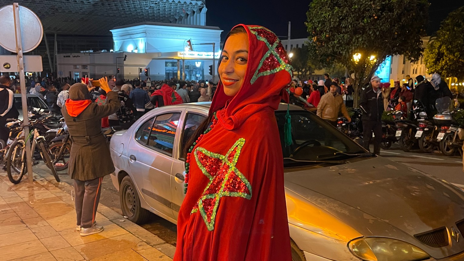 Moroccan fan Fatima Zahra Harimi celebrates her team's win at the Qatar World Cup in Rabat on 10 December 2022 (MEE/Austin Bodetti)