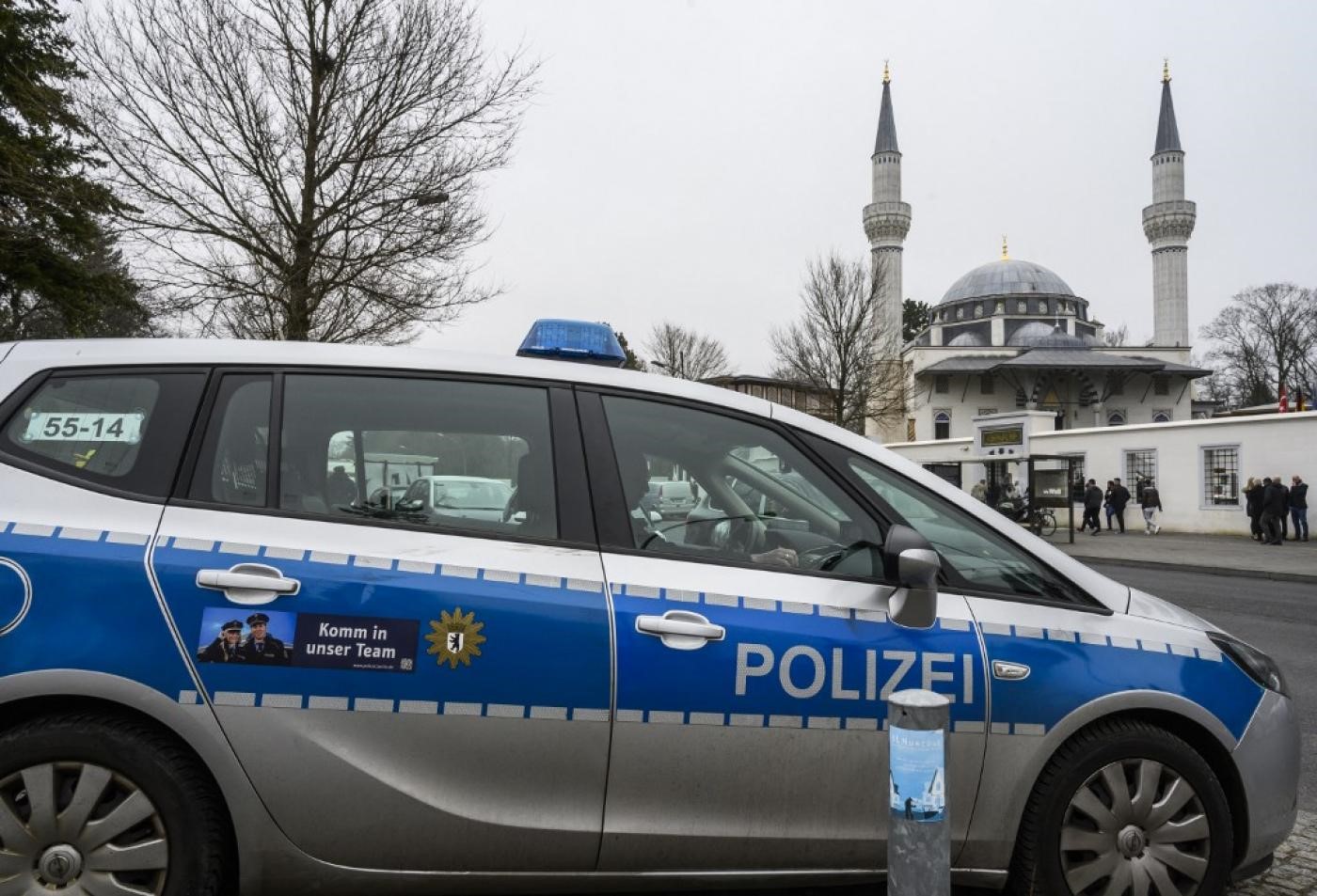 A police car outside a mosque, March 2019 (AFP)