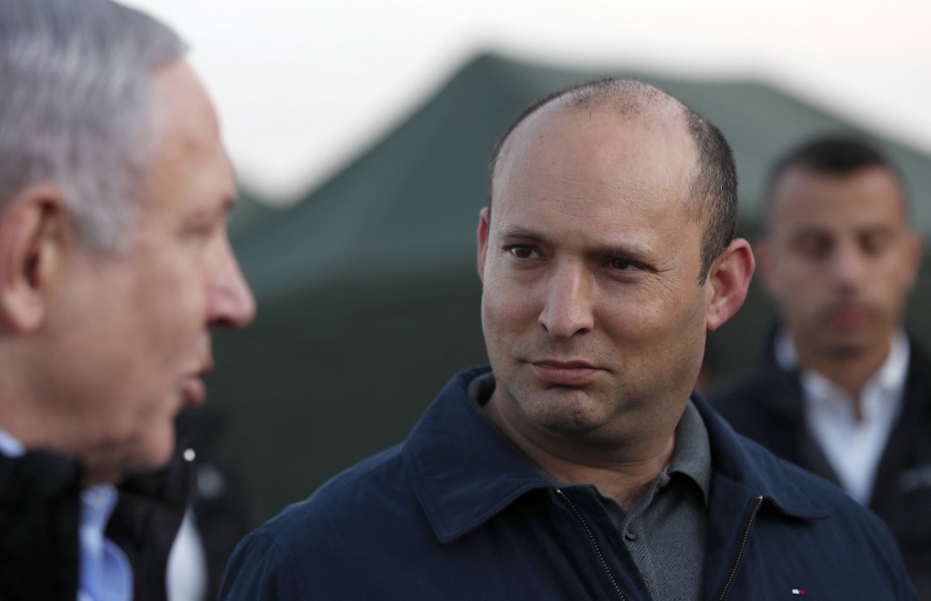 Israeli Prime Minister Benjamin Netanyahu and Naftali Bennett, then the defence minister, are pictured in the Golan Heights in 2019 (AFP)