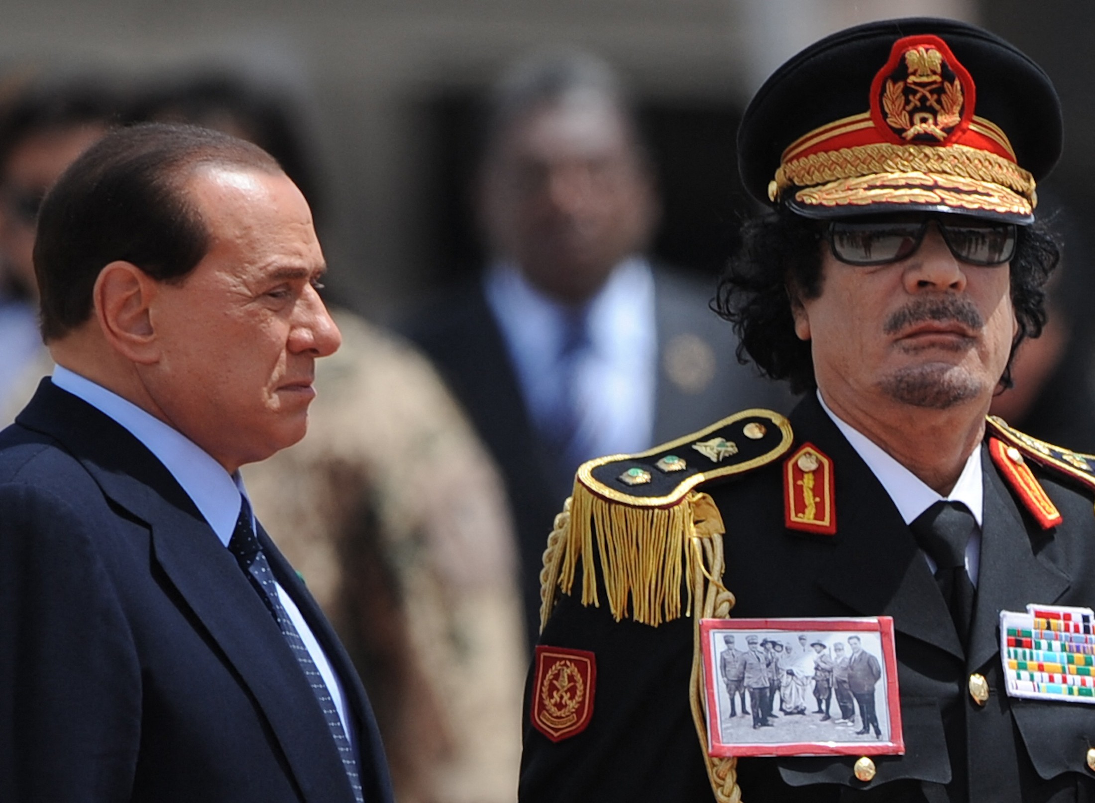 Kadhafi porte une photo historique d’Omar al-Mokhtar, le « lion du désert », capturé par des soldats italiens, à l’arrivée du dirigeant nord-africain à l’aéroport Ciampino à Rome, en Italie, le 10 juin 2009 (AFP)