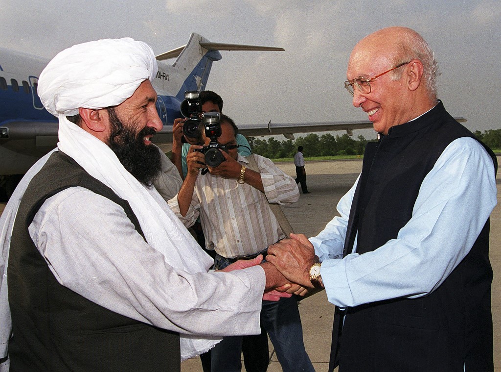 Pakistan’s foreign minister receives his Afghan Taliban counterpart, Mullah Akhund (L), near Islamabad in August 1999 (AFP)