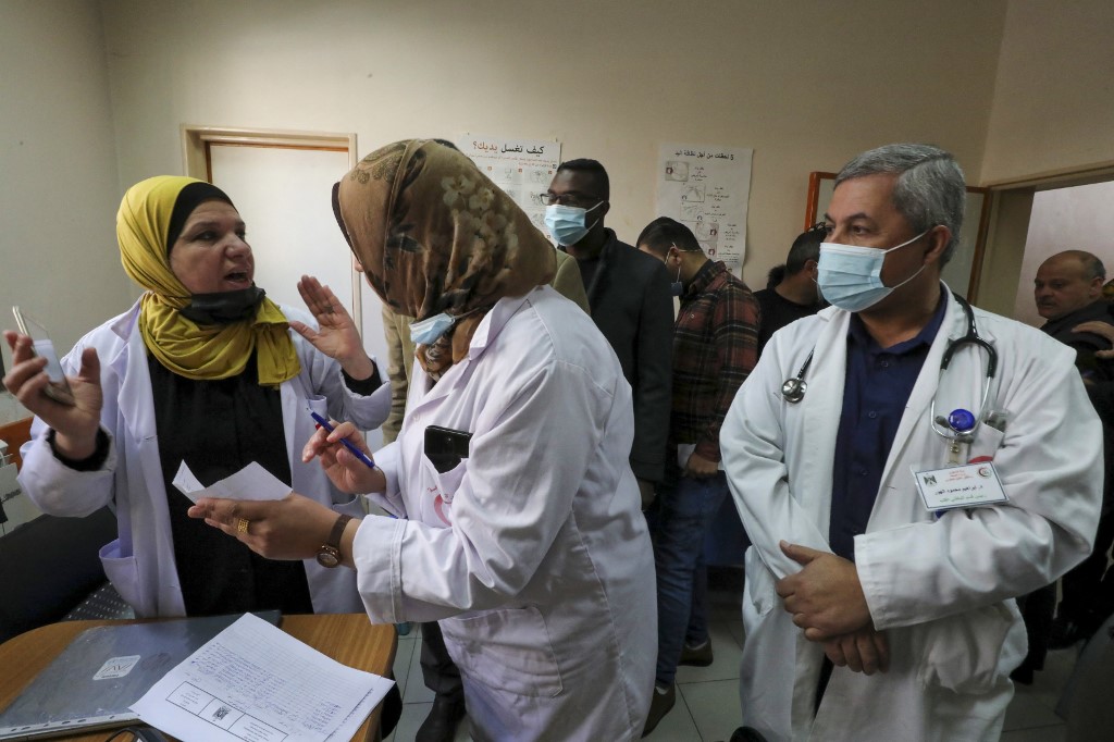 Palestinian nurses prepare to administer the Covid-19 vaccine in Hebron on 9 March 2021 (AFP)