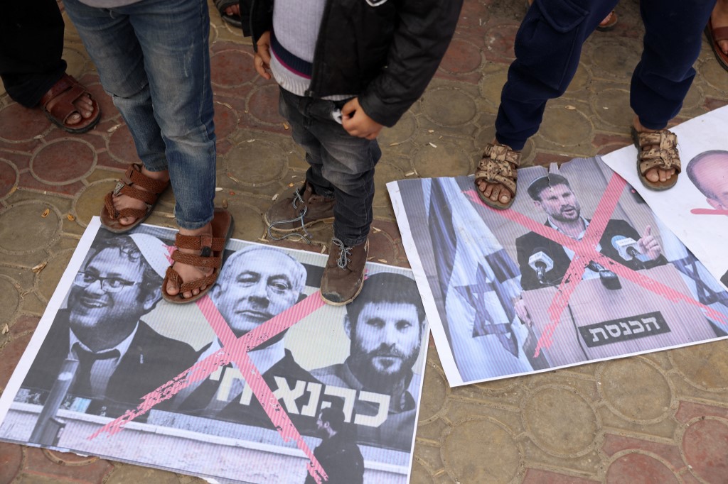 Palestinian protesters step on posters of Smotrich, Israeli Prime Minister Benjamin Netanyahu and National Security Minister Itamar Ben-Gvir in January 2023 (AFP)