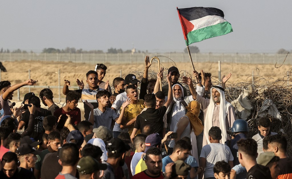 Palestinians protest near the Gaza fence on 25 August 2021 (AFP)