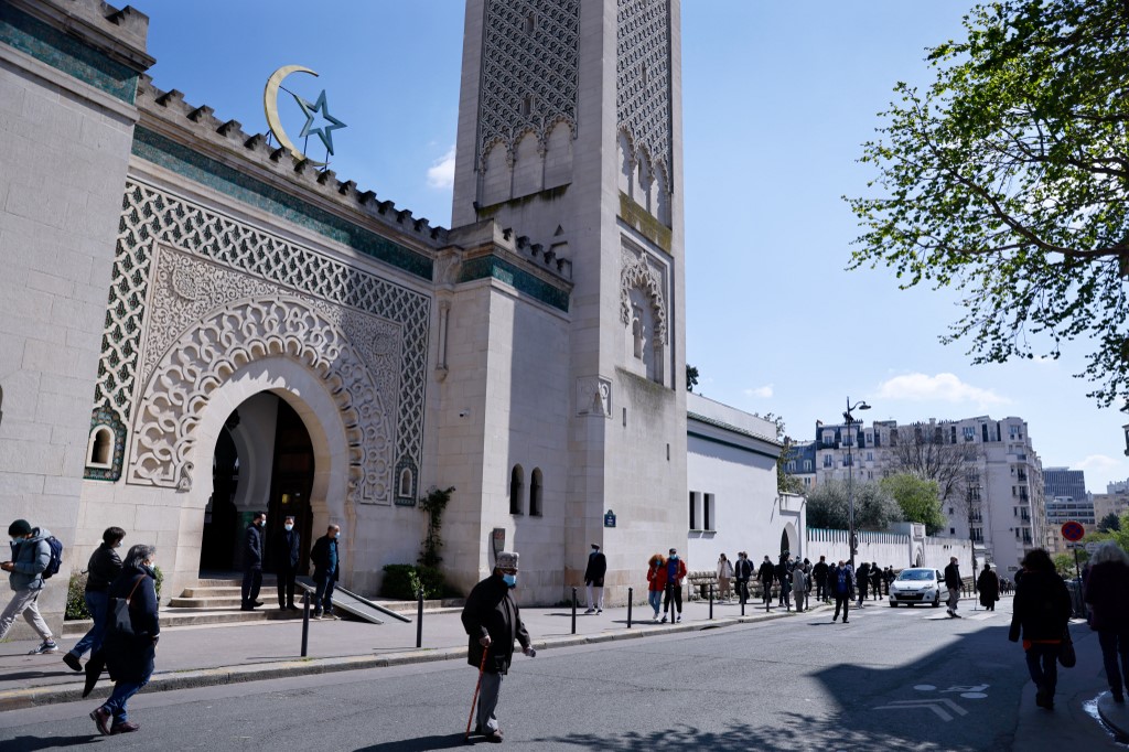 People walk outside the Grand Mosque of Paris on 13 April 2021 (AFP)