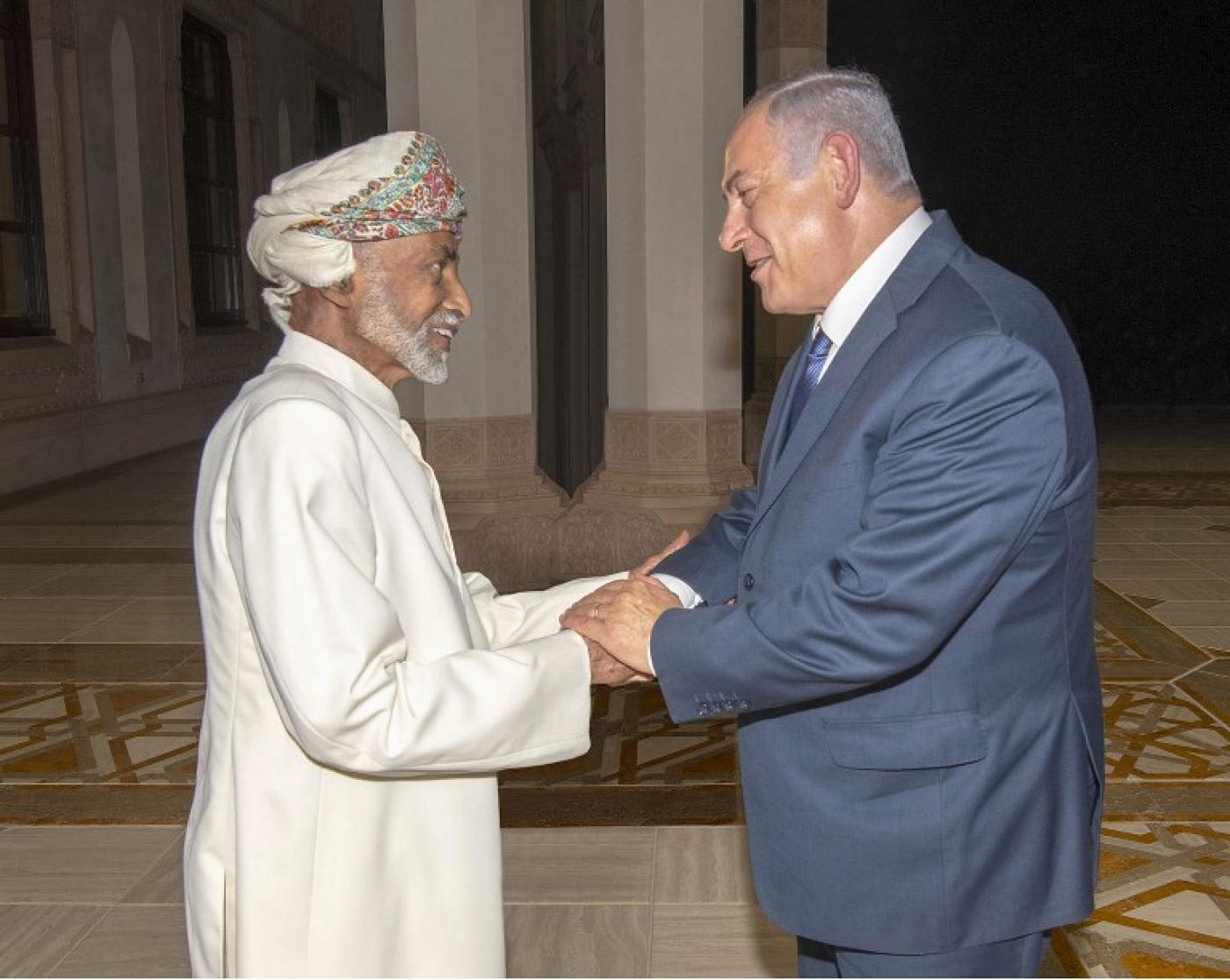A handout picture released by the Omani Royal Palace shows Oman's Sultan Qaboos, left, with Israeli Prime Minister Benjamin Netanyahu in Muscat on 26 October (AFP)