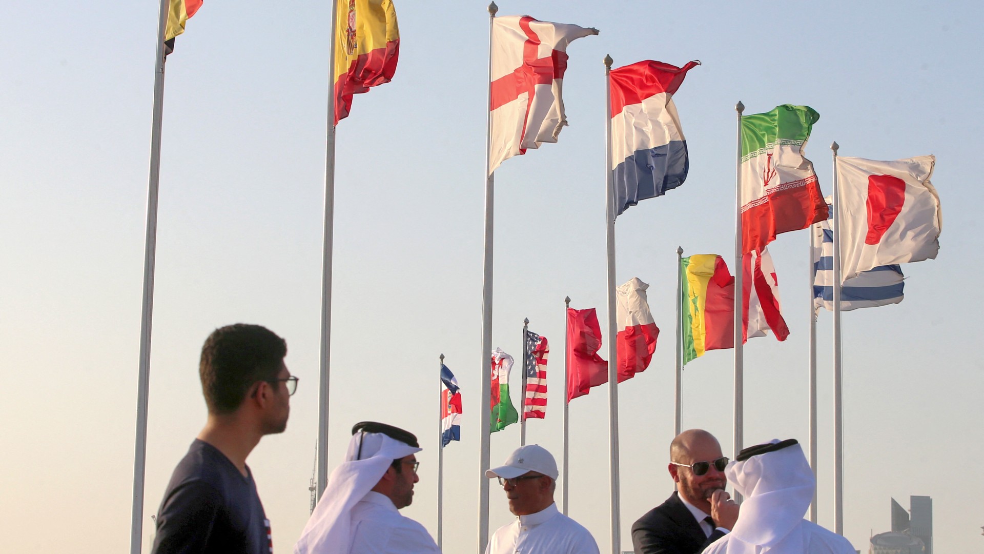 A general view shows flags of the qualified countries for the 2022 World Cup in the Qatari capital Doha during a flag-raising ceremony of the last remaining countries to qualify, on June 16, 2022.