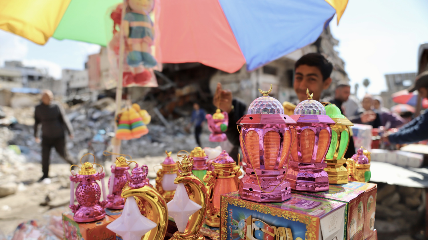 Lanterns and toys on a stand facing the destruction in northern Gaza (Mohammed al-Hajjar/MEE).