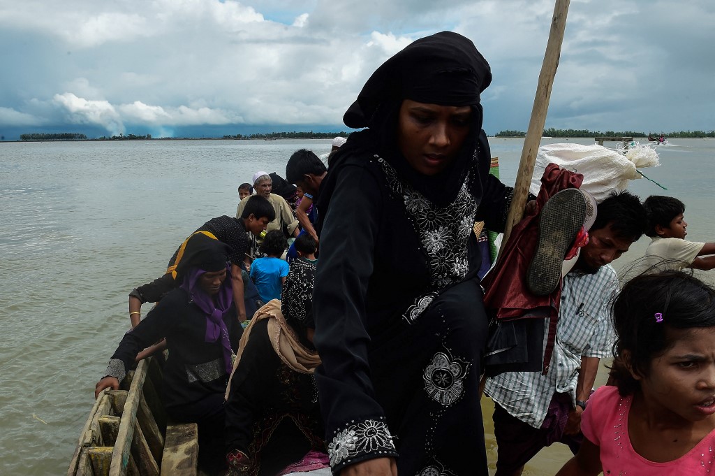 Rohingya Muslim refugees disembark from a boat in Bangladesh in 2017 (AFP)