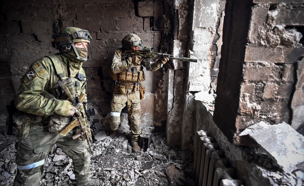 Russian soldiers patrol Mariupol, Ukraine, on 12 April 2022 (AFP)