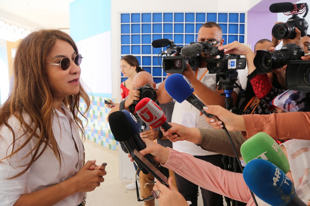 Karoui's wife Salwa Smaoui speaks to journalists after voting in Sunday's legislative elections (AFP)