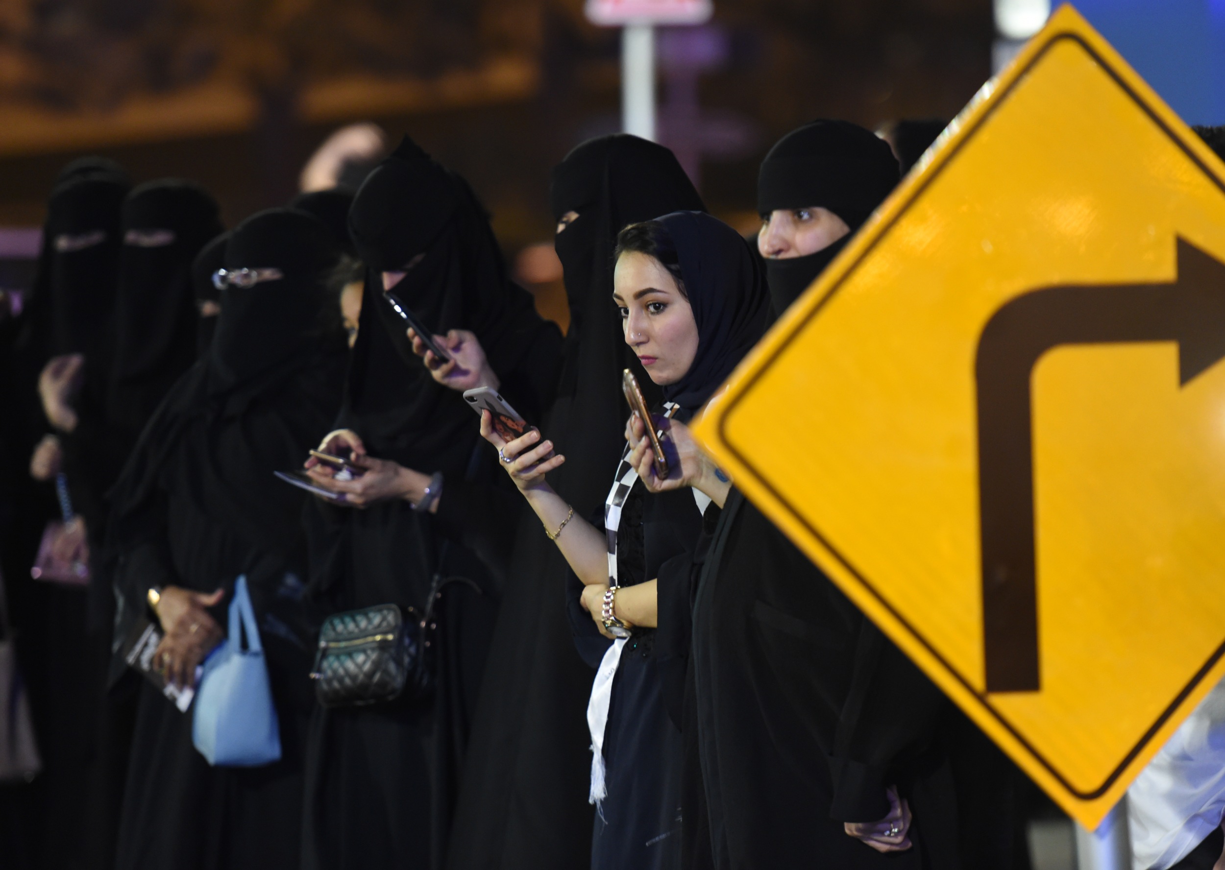 Saudi women look at their phones in the capital Riyadh on 21 June 2018 (AFP)