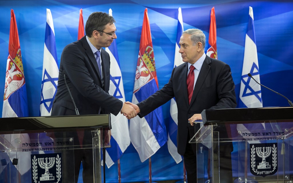 Israeli Prime Minister Benjamin Netanyahu shakes hands with Vucic in Jerusalem in 2014 (AFP)