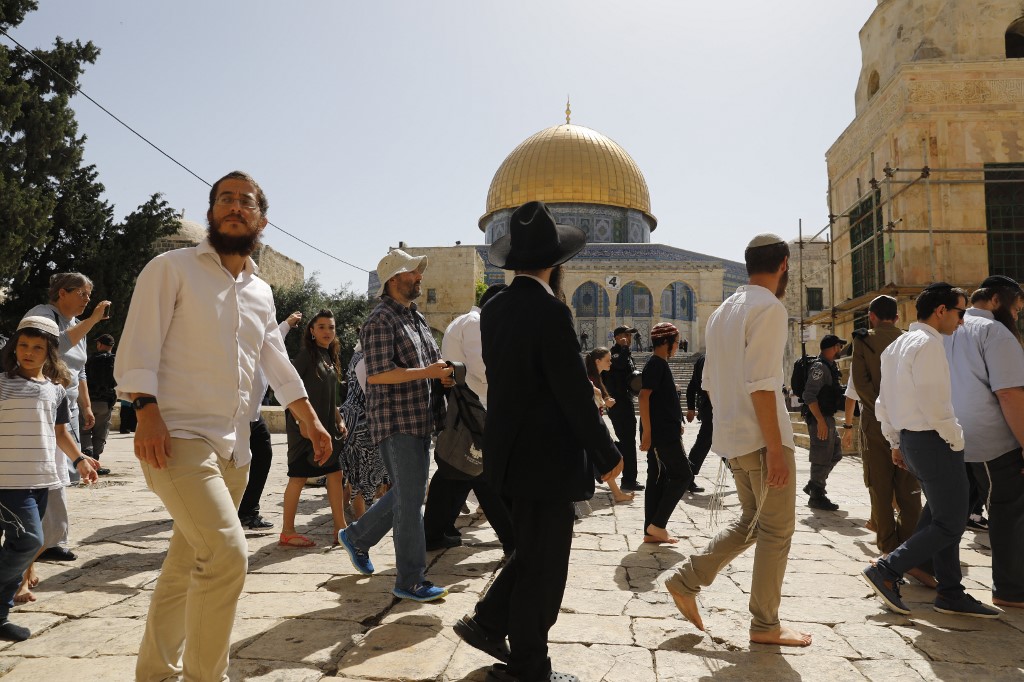 Israeli security forces escort Jewish settlers at Jerusalem’s al-Aqsa Mosque compound on 2 June (AFP)