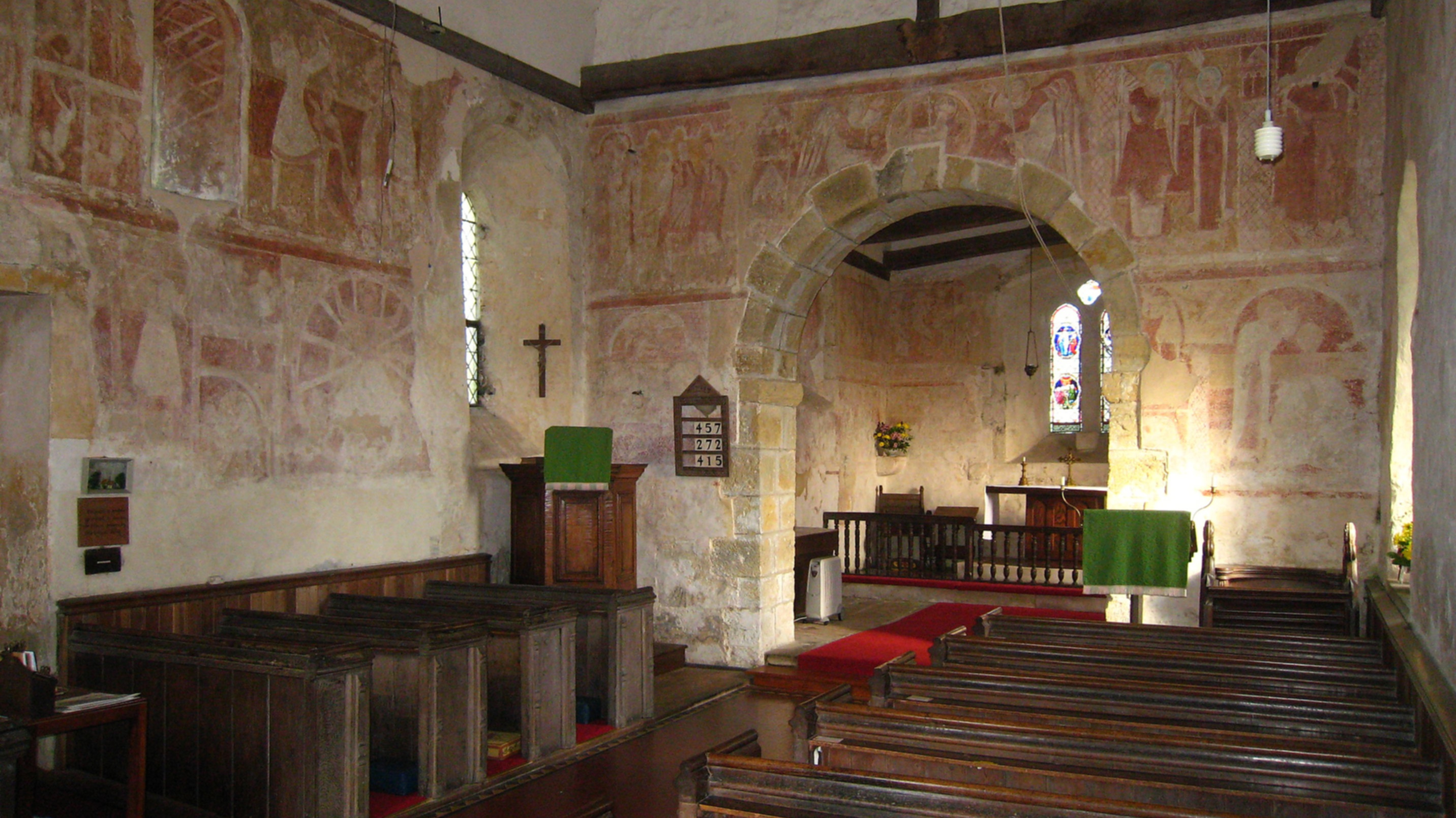 The interior wall paintings at St Botolph’s Church are pictured in Hardham, West Sussex (Michael Coppins/Wikimedia Commons)