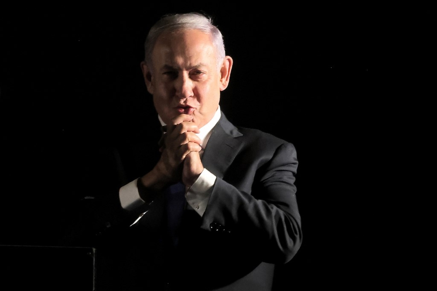Former Israeli prime minister and current leader of the opposition Benjamin Netanyahu gestures to supporters during an anti-government protest in Jerusalem on 6 April 2022. (AFP)